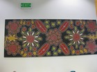 IMG_0395  Aboriginal tapestry.   Darwin State Library. U symbols represent women sitting around fires.JPG
