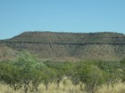 IMG_0491  Savannah woodland, and a rocky range with a dark iron layer.JPG